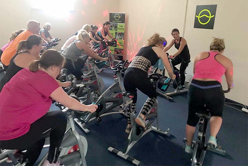 people on spinning cycles in newport