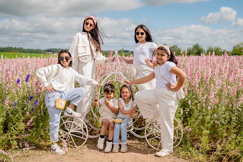 children standing in field of petals