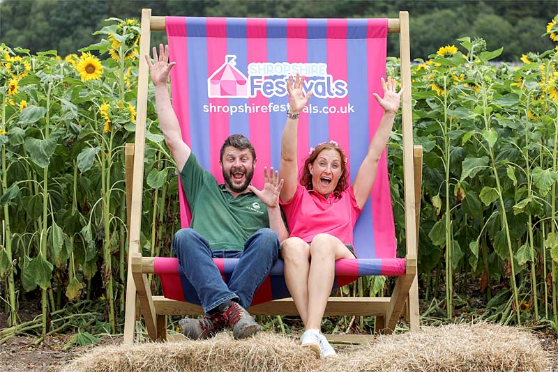 beth heath sits in giant desck chair
