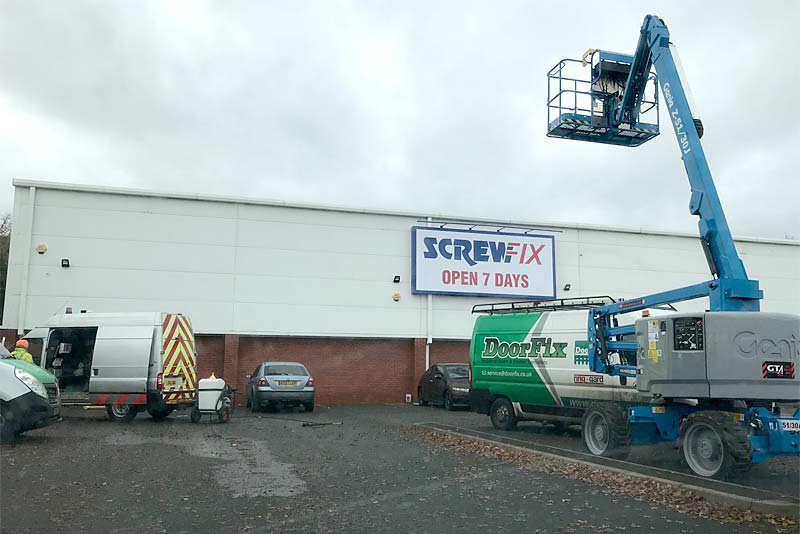 crane fixes new sign at screwfix newport