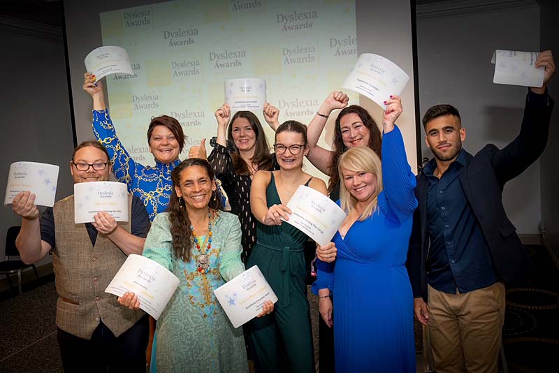 award winners hold their certificates for the camera