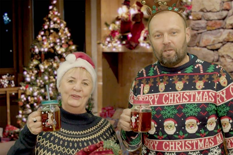 two people raising a glass atchristmas