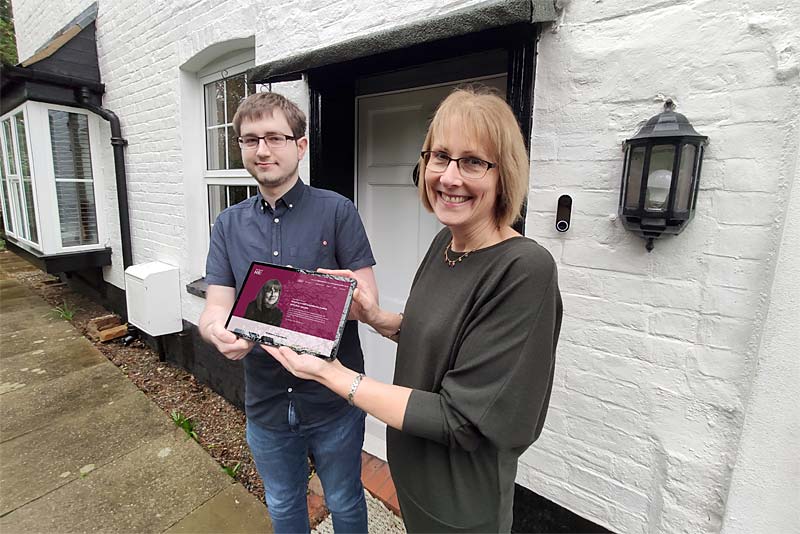kay heald holds laptop with new website