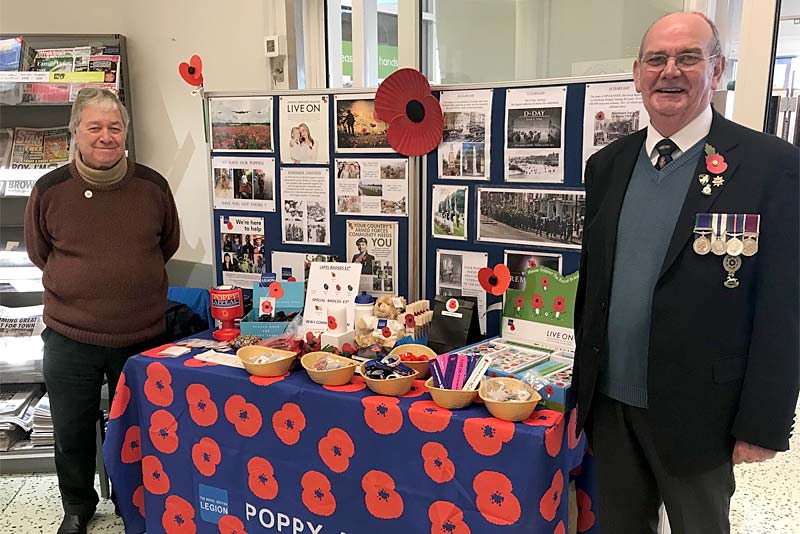 military personnel selling poppies