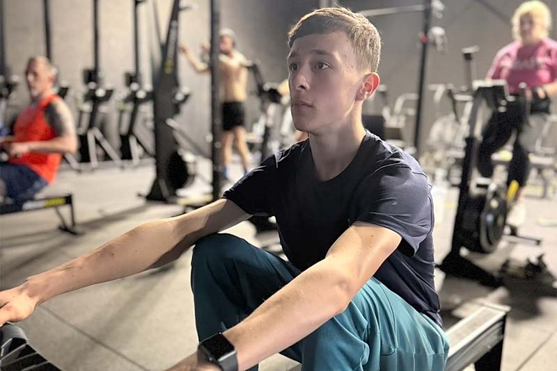 tusker hanlon working out on a rower